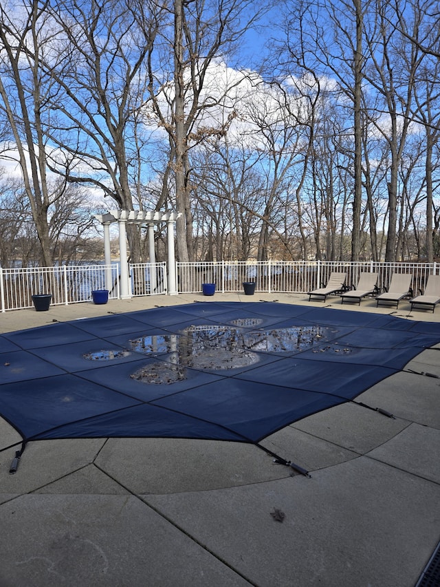 view of pool featuring a patio area, fence, a pergola, and a fenced in pool