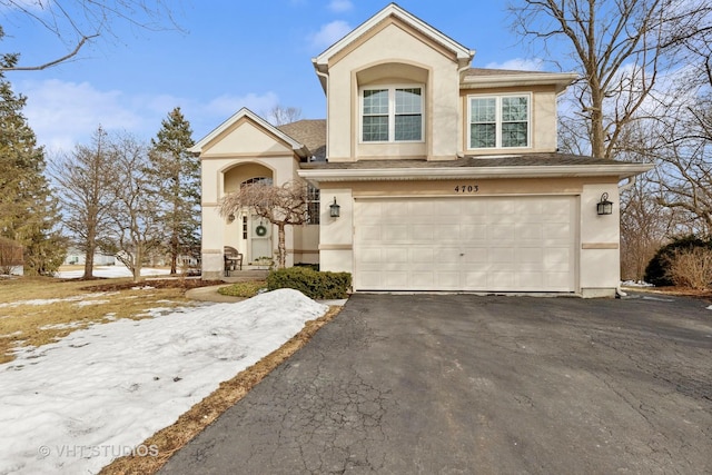 view of front of property featuring a garage, driveway, and stucco siding