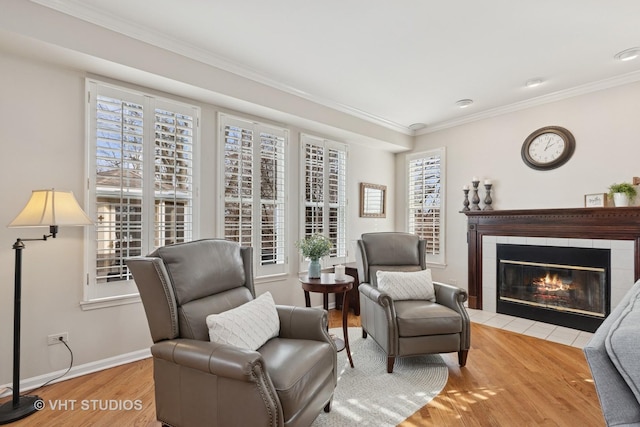 living area with ornamental molding, plenty of natural light, wood finished floors, and baseboards