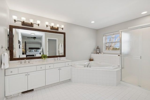 bathroom with a bath, connected bathroom, a sink, and tile patterned floors