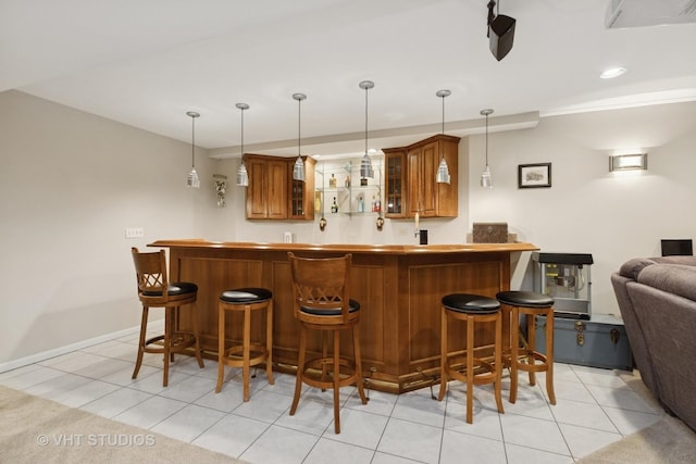 bar featuring wet bar, light tile patterned flooring, and decorative light fixtures