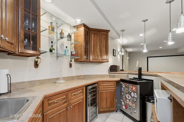 kitchen featuring hanging light fixtures, light tile patterned floors, wine cooler, and brown cabinetry