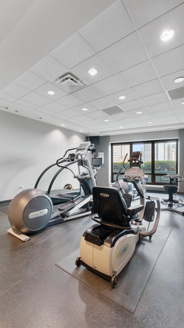 workout area featuring a drop ceiling and visible vents