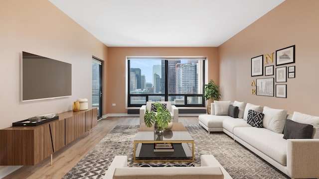 living room with light wood-style flooring and baseboards