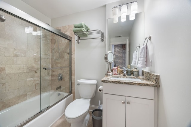 full bathroom with toilet, combined bath / shower with glass door, and vanity