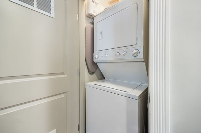 laundry area with laundry area and stacked washer and clothes dryer