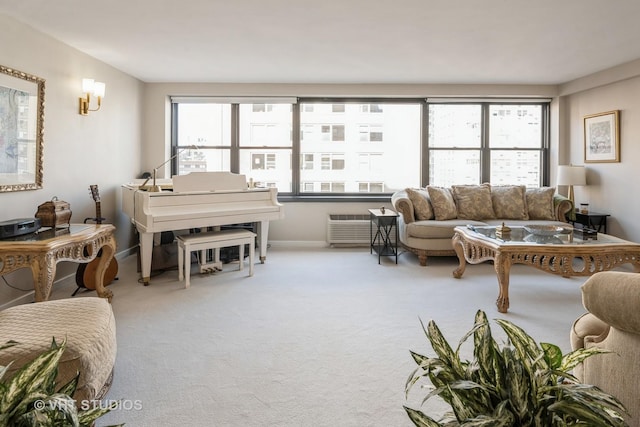 carpeted living area with a healthy amount of sunlight, baseboards, and a wall mounted AC