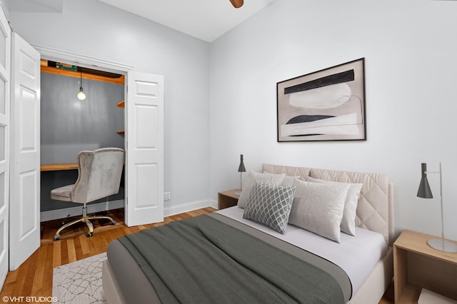 bedroom featuring baseboards and wood finished floors