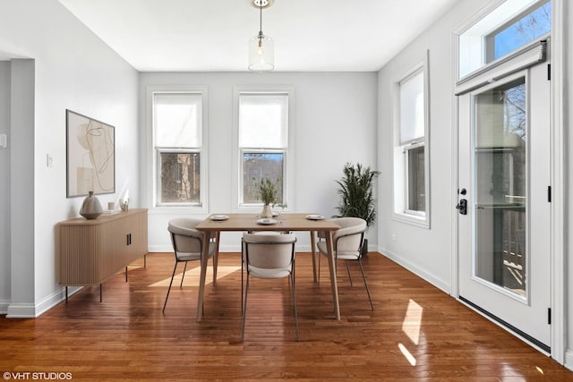 dining area featuring wood finished floors and baseboards