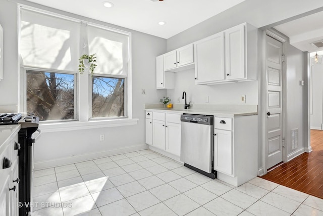 kitchen with light countertops, white cabinets, visible vents, and appliances with stainless steel finishes