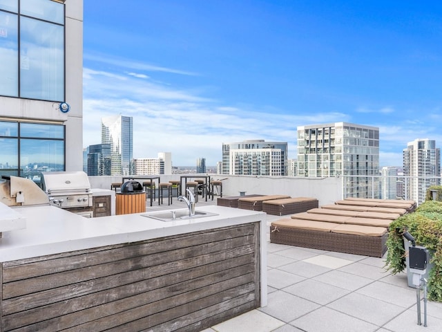 view of patio / terrace with area for grilling, a sink, grilling area, outdoor lounge area, and a view of city