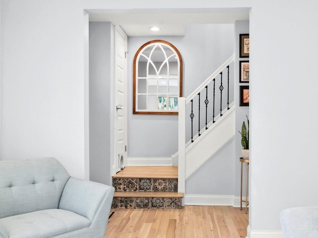 stairs featuring recessed lighting, wood finished floors, and baseboards