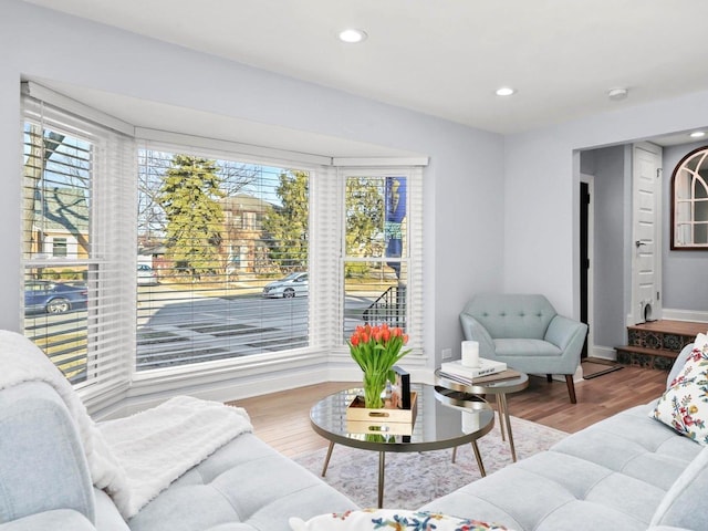 living room featuring a wealth of natural light, baseboards, wood finished floors, and recessed lighting