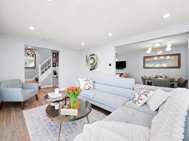 living area with stairs, recessed lighting, baseboards, and light wood finished floors