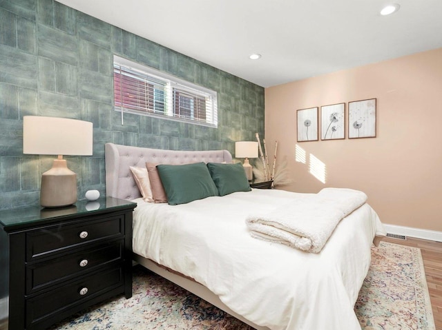 bedroom with recessed lighting, baseboards, and wood finished floors