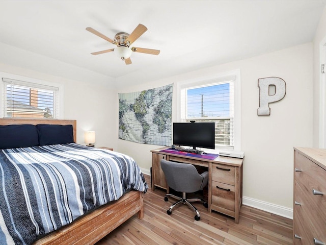 bedroom featuring light wood-type flooring, baseboards, and ceiling fan