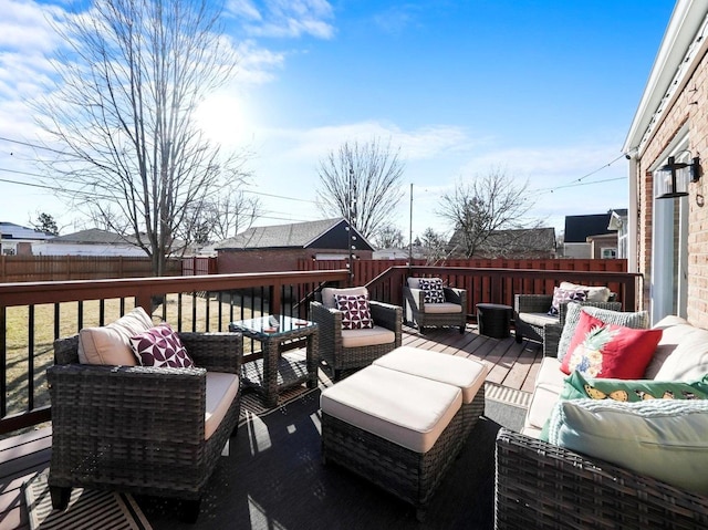 deck featuring an outdoor living space and a fenced backyard