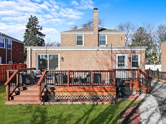 back of house with fence, a lawn, brick siding, and a chimney