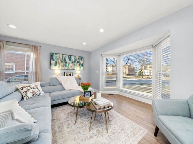 living area with plenty of natural light, recessed lighting, and wood finished floors