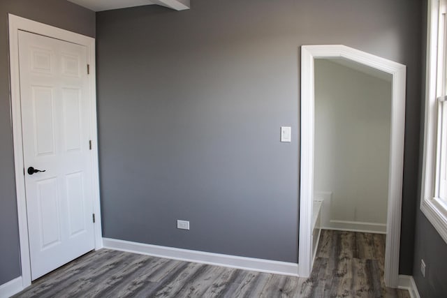 unfurnished bedroom featuring baseboards and wood finished floors