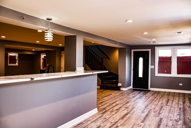 foyer with stairs, baseboards, wood finished floors, and recessed lighting