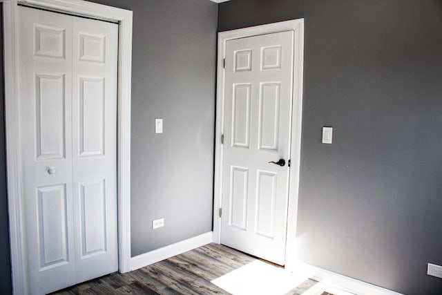 unfurnished bedroom featuring baseboards and wood finished floors