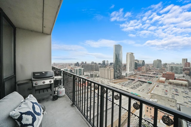 balcony with area for grilling and a city view