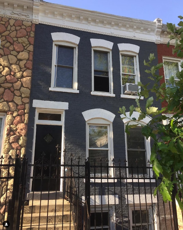 view of front facade featuring a fenced front yard and brick siding