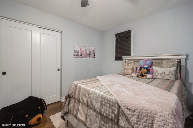 bedroom with a closet, wood finished floors, and a ceiling fan