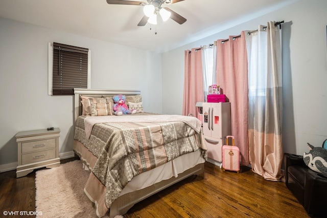 bedroom featuring ceiling fan, wood finished floors, and baseboards