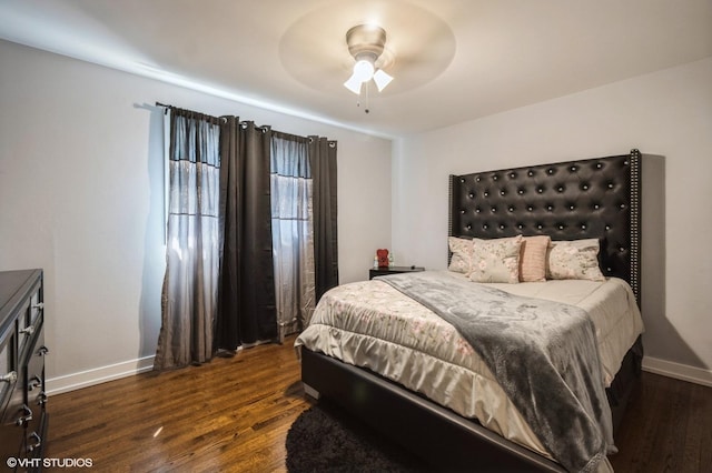 bedroom with baseboards and dark wood-type flooring