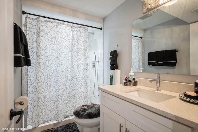 full bath with a shower with curtain, vanity, and toilet