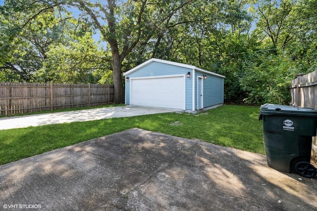 exterior space with an outbuilding, fence, and a garage