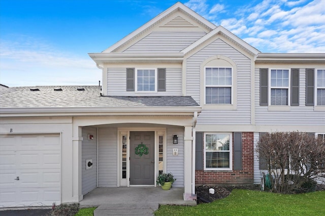 view of front of home with a garage, brick siding, and a shingled roof