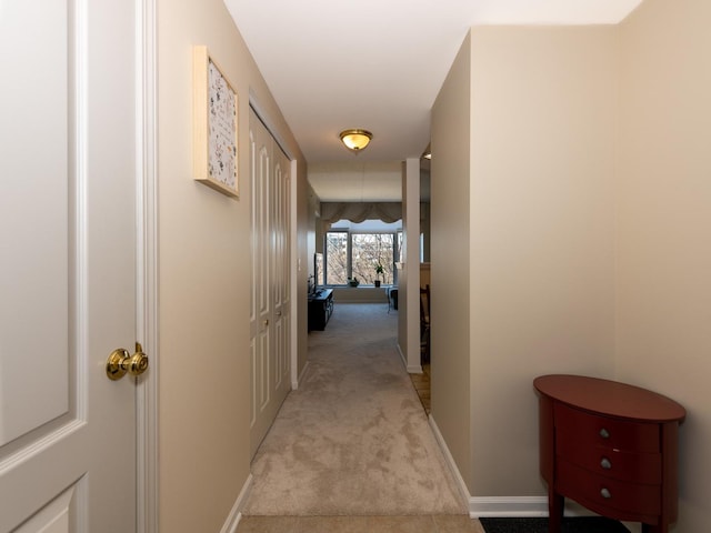 hall with light carpet and baseboards