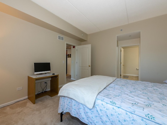 bedroom featuring carpet floors, visible vents, and baseboards