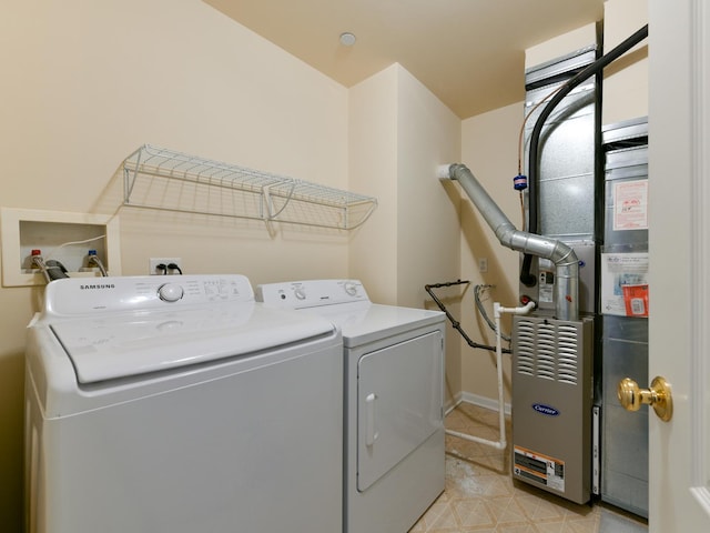 laundry room featuring washer and dryer, laundry area, and heating unit