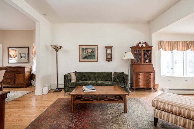 living room featuring a baseboard radiator and light wood-style flooring