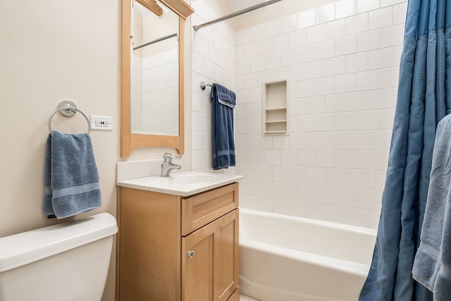 bathroom with vanity, toilet, and shower / bath combo with shower curtain