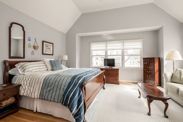 bedroom featuring vaulted ceiling and light wood-style flooring