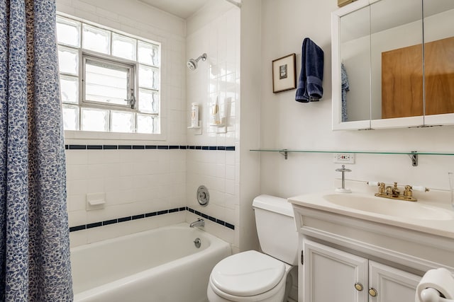 full bathroom featuring toilet, shower / bath combination with curtain, and vanity