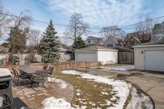 view of yard featuring an outbuilding, a patio, outdoor dining area, and a fenced backyard