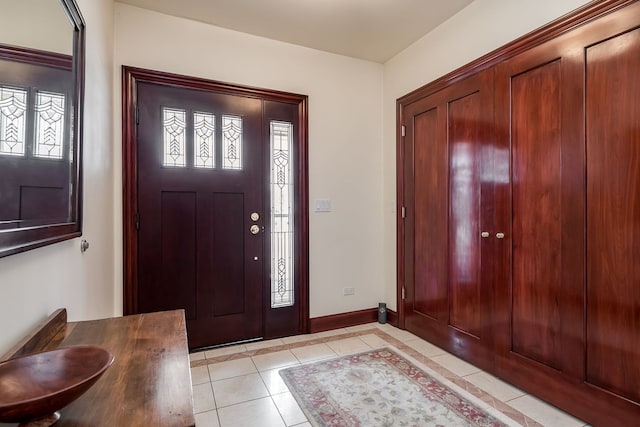 entrance foyer featuring a wealth of natural light, baseboards, and light tile patterned floors