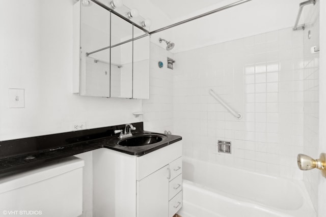 bathroom with toilet, vanity, and shower / bathtub combination