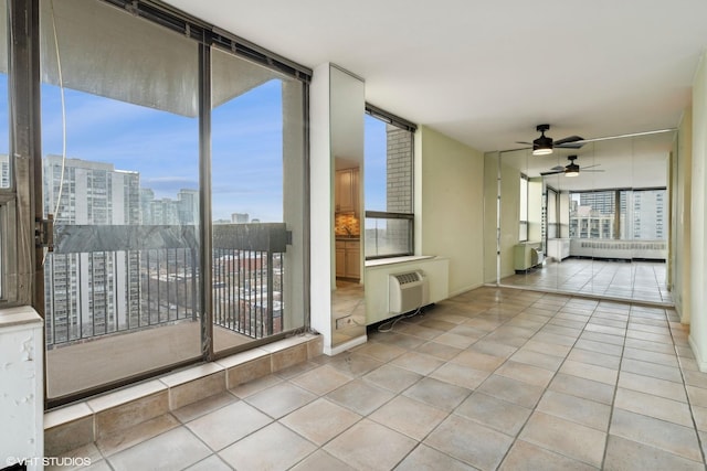 interior space featuring ceiling fan, a view of city, and a wall mounted air conditioner