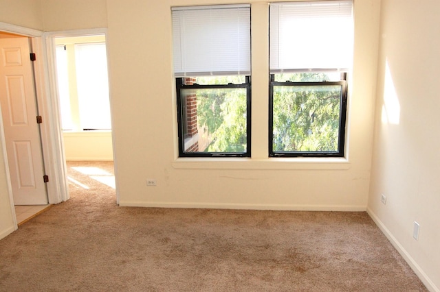 unfurnished room featuring baseboards and carpet flooring