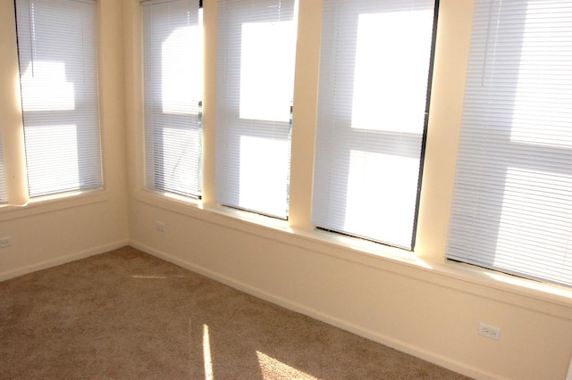 empty room with baseboards and carpet flooring
