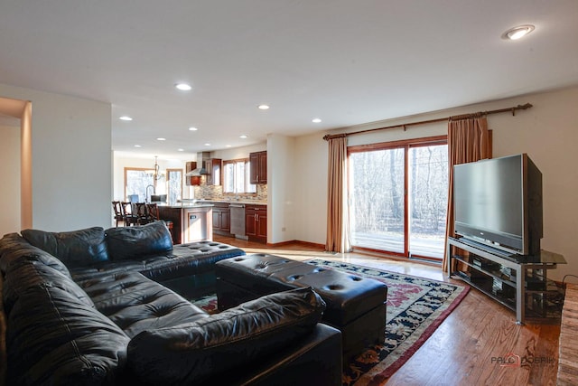 living area featuring light wood finished floors and recessed lighting