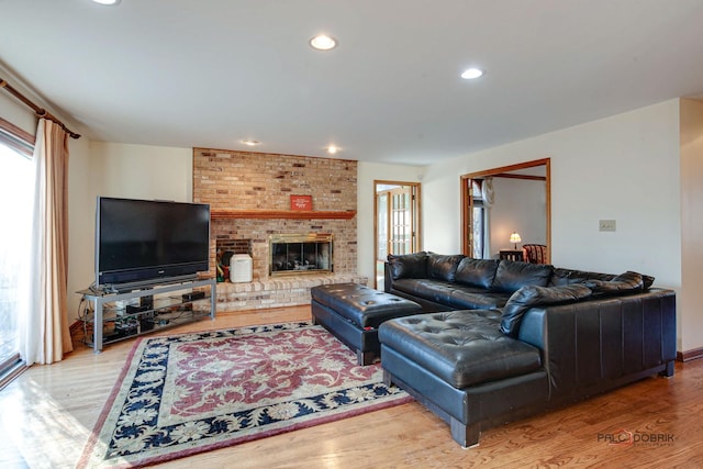 living room with a fireplace, wood finished floors, and recessed lighting