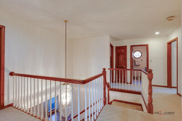 corridor with recessed lighting, carpet flooring, an upstairs landing, and baseboards